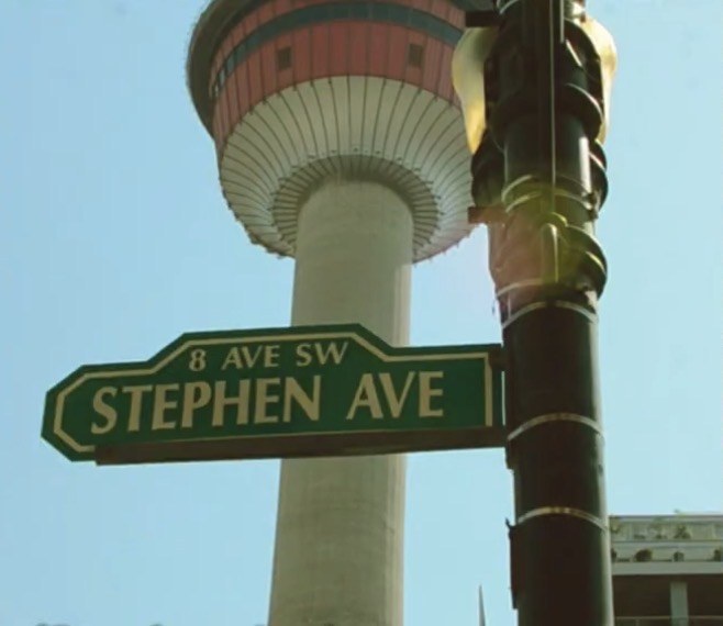 The Stephen Avenue street sign in front of the Calgary Tower on a sunny day